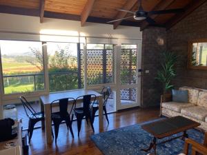 a living room with a table and chairs and a couch at Mount Hope Estate Vineyard in Dixons Creek