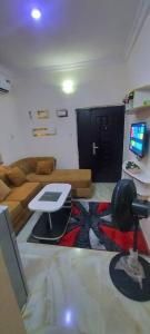 a living room with a couch and a table with a laptop at Nasaplace Venture in Badore