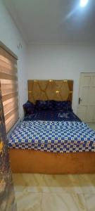 a bedroom with a large bed with a wooden headboard at Nasaplace Venture in Badore