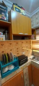 a kitchen with a shelf with shoes and a sink at Nasaplace Venture in Badore