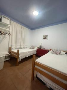 a room with two beds in a room at Refugio del Mirador in Vélez-Málaga