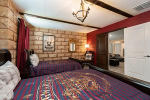 a hotel room with a bed and a living room at Charming 9BR Villa w Theme & Game Rooms by Disney in Kissimmee