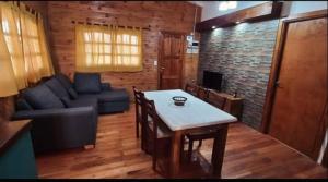 a living room with a couch and a table at Hospedaje la luna in San Miguel del Monte