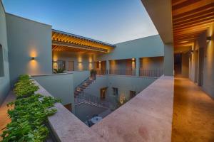 an indoor courtyard of a house with stairs and plants at HOTEL CASA ARANZAZU SAN LUIS POTOSI in San Luis Potosí