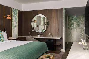um quarto de hotel com uma cama e um espelho em Crowne Plaza Dublin Blanchardstown, an IHG Hotel em Blanchardstown