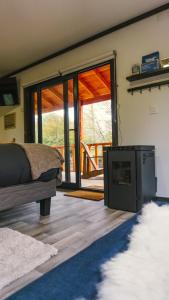 a bedroom with a bed and a tv in a room at tiny house suite deluxe QT en Malalcahuello in Malalcahuello
