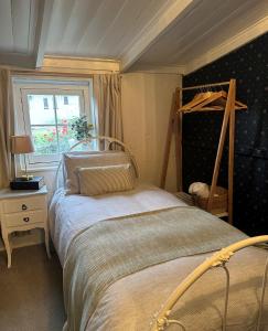 a bedroom with a bed and a window at Ulva Cottage - Historical BnB in Penola