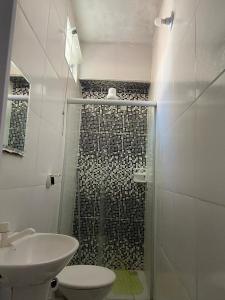 a bathroom with a shower with a toilet and a sink at Pousada Familia Aparecida in Aparecida +74 photos