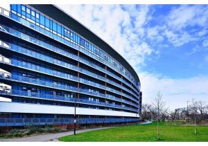 a large building with blue windows on the side of it at 2BR Flat at Meath Crescent in London