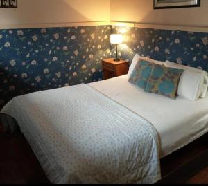 a bedroom with a bed with a floral wallpaper at Bungalows Spa La Delfina in Gualeguaychú