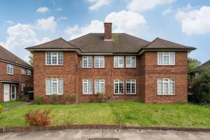 a large brick house with white windows at Stylish 2BR Oasis Steps from Wembley Stadium in London