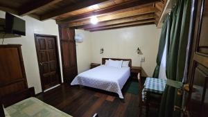 Postel nebo postele na pokoji v ubytování Hostería Finca El Pigual