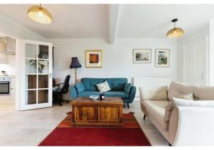 a living room with a couch and a coffee table at 3BR Cheltenham Home - Elegance and Comfort in Cheltenham