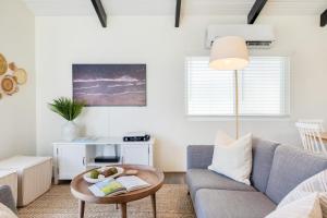 a living room with a couch and a table at Surfrider II by AvantStay Walk to the Beach Balcony in Newport Beach