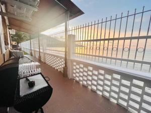 a balcony with a bench and a view of the ocean at Seaview Mini Chalet by StayCo - DIRECT BEACH ACCESS in Tanjung Bungah