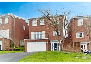 a large brick house with a white garage at 5BR Family Home close to Parks and City Links in Purley