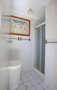 a bathroom with a shower and a glass door at On Agnes Time - Beach house in sunny Agnes Water in Agnes Water