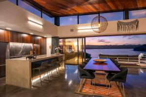 a kitchen with a view of the water at Nook Bay House in Whangarei