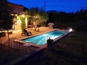 a swimming pool in a backyard at night at Beautiful villa with private pool in the Luberon in Cucuron