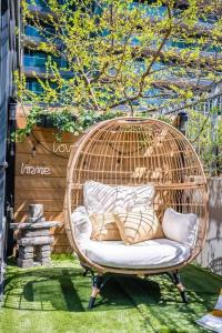 a wicker chair sitting on the grass in a garden at Luxury Suite With Private Terrace Downtown Toronto in Toronto