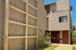 a building with a wooden ladder on the side of it at Casa Beverly Hills Pysá 02 Milagres Nobile Stays in São Miguel dos Milagres
