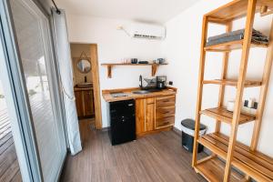 a tiny house with a kitchen and a bunk bed at Panama Kite Center in Punta Chame