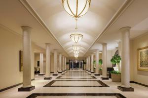 a hallway of a building with columns and a chandelier at Nagoya Marriott Associa Hotel in Nagoya