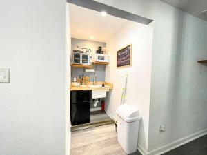 a small kitchen with a sink and a toilet at Mangosteen in New Orleans