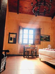 a dining room with a table and a window at Casa Familiar San Sebastian in Antigua Guatemala