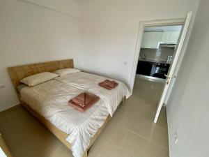 ein Schlafzimmer mit einem Bett und einer Tür zu einer Küche in der Unterkunft Costante 614 in Durrës