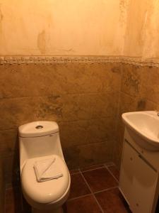 a bathroom with a toilet and a sink at Casa Familiar San Sebastian in Antigua Guatemala
