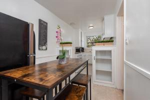 a kitchen with a wooden table and a refrigerator at Modern Charming 1BR-Apartment with Hot Tub in Los Angeles