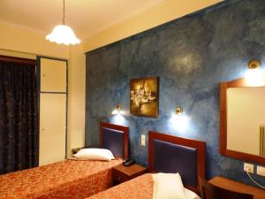 Postel nebo postele na pokoji v ubytování Pergamos Hotel