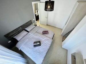 a bedroom with a large bed with white sheets at Villa Golem 595 in Golem