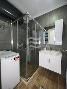 a bathroom with a shower and a sink at Essential 516 in Durrës