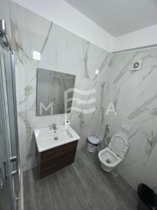 a bathroom with a sink and a toilet at Interstellar 830 in Durrës