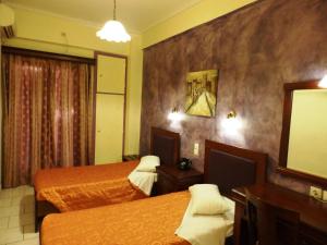 Postel nebo postele na pokoji v ubytování Pergamos Hotel