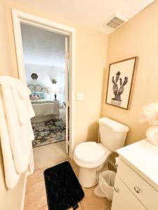 a bathroom with a toilet and a bedroom at Stylish 2 bedroom near Ontario Airport in Fontana