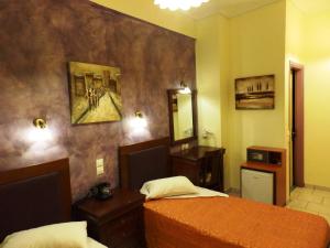 Postel nebo postele na pokoji v ubytování Pergamos Hotel