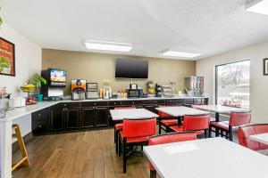 a restaurant with tables and chairs and a flat screen tv at Econo Lodge Downtown in Augusta
