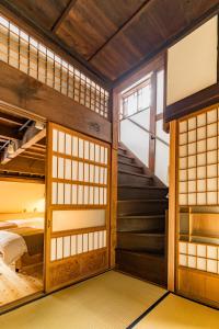 a room with two bunk beds and a staircase at 城下町家 茶庭 飛び石 BBQ 筍 金蔵Kinzo in Ōtaki