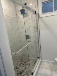 a shower with a glass door in a bathroom at City access in Washington