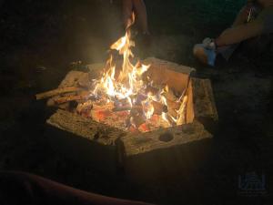 a fire is burning in a brick oven at Cabañas Alpinas en Oxapampa in Oxapampa