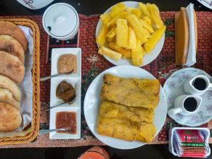 a table with plates of food and french fries at Cabañas Alpinas en Oxapampa in Oxapampa