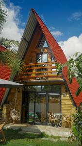 a house with an orange roof with a patio at Cabañas Alpinas en Oxapampa in Oxapampa