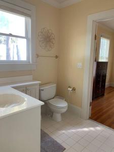 a white bathroom with a toilet and a window at Estate lot! Waterfront! in Beaufort +33 photos