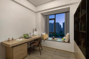 an office with a desk and a window with a view at Somerset Star River Minhang Shanghai in Shanghai