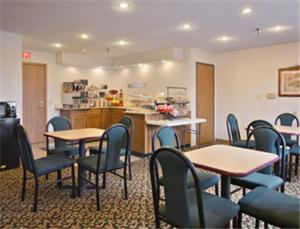 a waiting room with tables and chairs in a hospital at Super 8 by Wyndham Crawfordsville in Crawfordsville