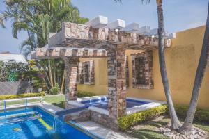 a house with a swimming pool next to a building at Casa Vacacional, Lomas Cocoyoc in Texcalpan