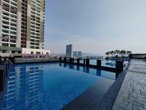 a large swimming pool in a city with buildings at Landmark2 Spacious Studio w Wi-Fi Netflix in Kajang